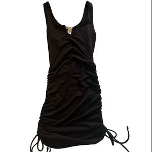 Brand new small black mini dress with lace on sides